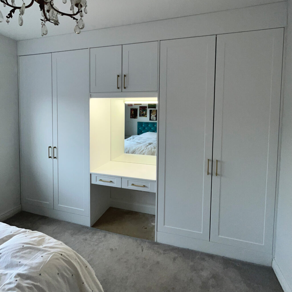 Bespoke built-in white Wardrobe with gold handles and built-in vanity case Weston County Dublin - McIntyre Carpentry